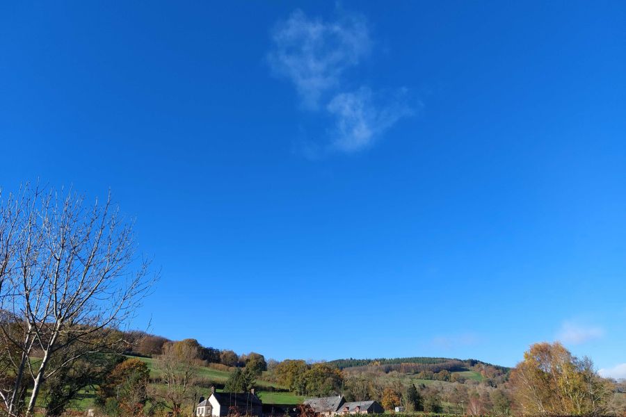 bright blue sky with one cloud